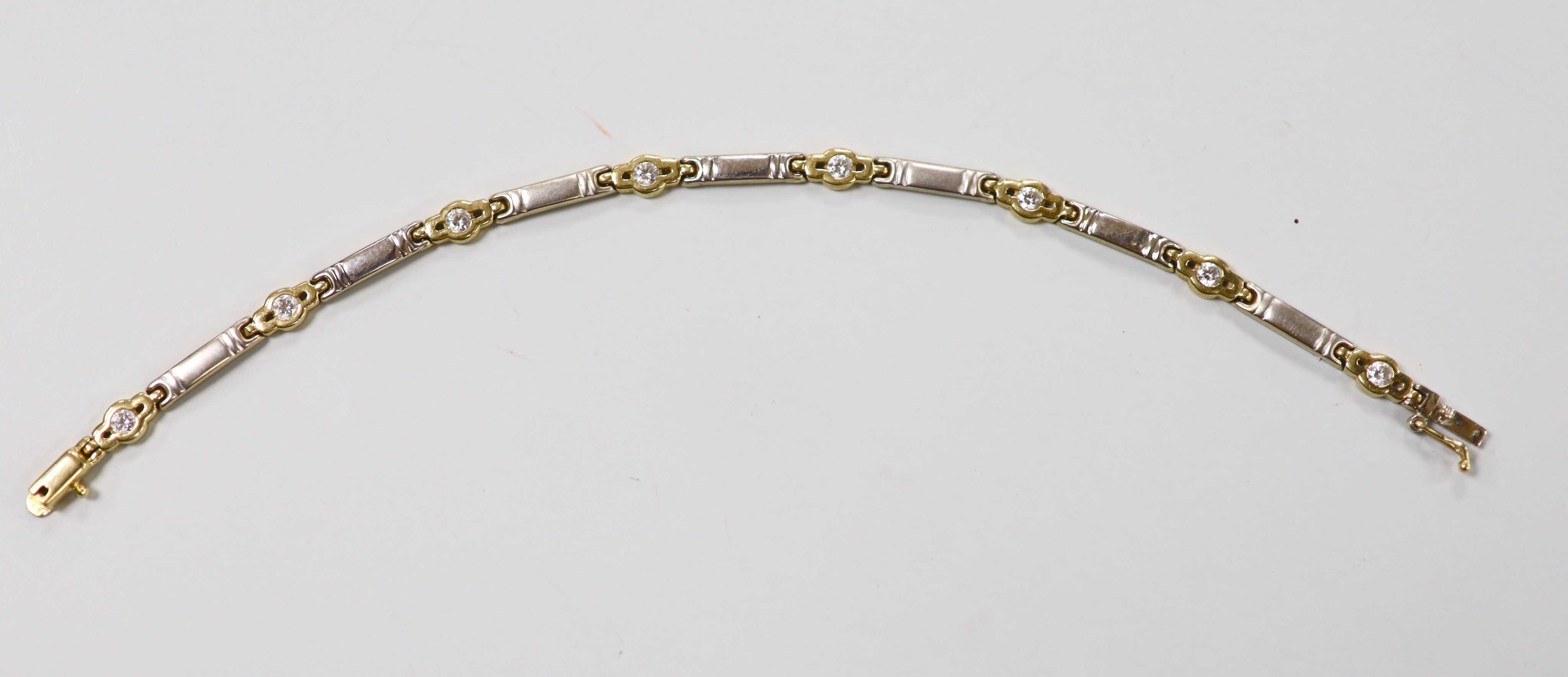 A 1940's 9ct gold heart shaped locket, 21mm, on a 9ct gold fancy link albert, 42cm, gross 18.5 grams, together with a 14k and simulated diamond set bracelet, gross 8.1 grams and one other bracelet.